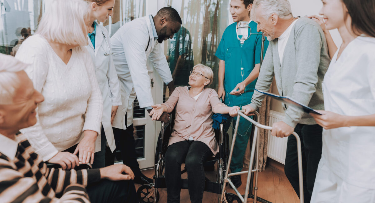 Smiling. Nurse. Medical Staff. Patient. Medical Dropper. Sitting Woman. Male. Doctor in Nursing Home. Patient with Walker. Nursing Home. Man with Crutches. Rehabilitation. Patient on a Wheelchair.
