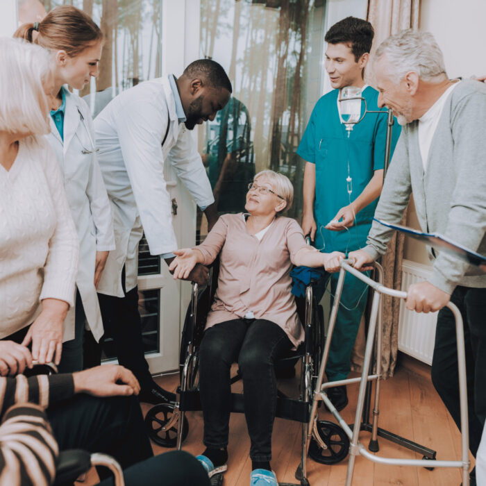 Smiling. Nurse. Medical Staff. Patient. Medical Dropper. Sitting Woman. Male. Doctor in Nursing Home. Patient with Walker. Nursing Home. Man with Crutches. Rehabilitation. Patient on a Wheelchair.