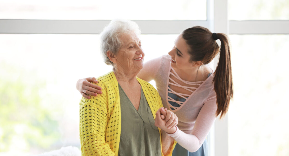 Caregiver with senior woman in nursing home