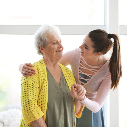 Caregiver with senior woman in nursing home