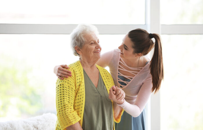 Caregiver with senior woman in nursing home